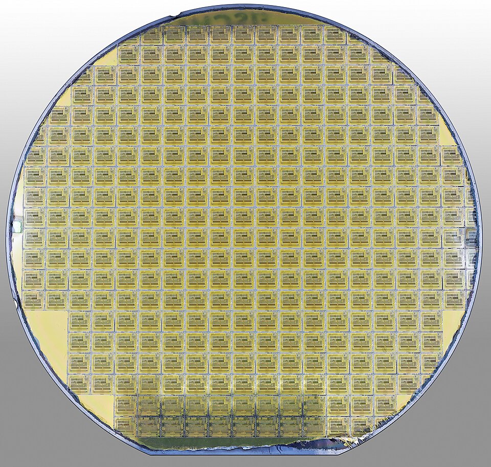 A finished wafer of 80C196KC 16-bit microcontrollers: hundreds of identical chips made side by side. The part-chips round the edge are waste; the share of good chips is the yield.