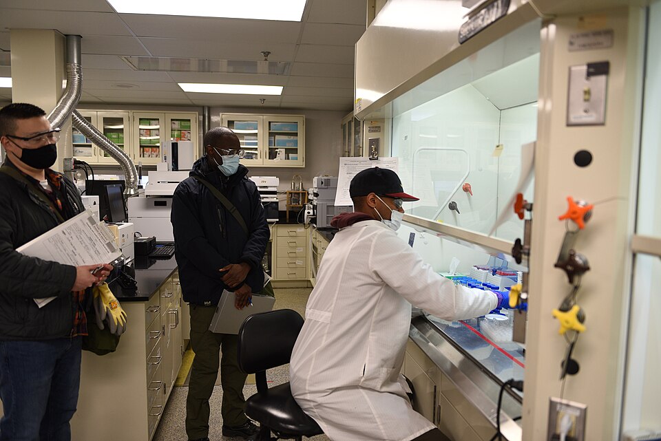 The on-site laboratory of the Blue Grass Chemical Agent-Destruction Pilot Plant: an analyst works at a fume hood, testing the plant's output to confirm the chemical agent has been destroyed.
