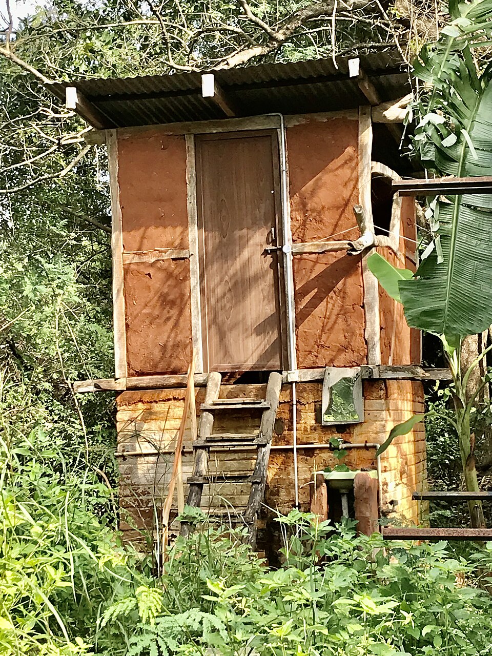 A raised composting latrine, vented and reachable from outside.