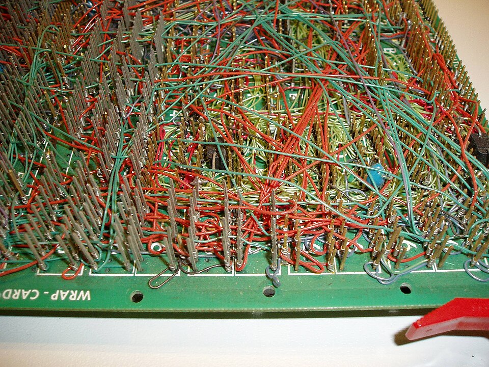 The back of a wire-wrapped Z80 computer board from 1977. Each connection is bare wire wound tightly round a square post, which makes a gas-tight joint without solder and can be unwrapped and changed.