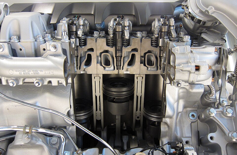 A sectioned diesel engine — combustion moved inside the cylinder, and power went mobile.