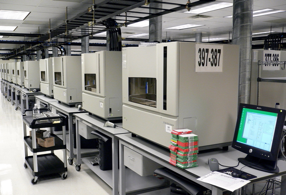 A row of DNA sequencers. Biology becomes something you can read and then write.