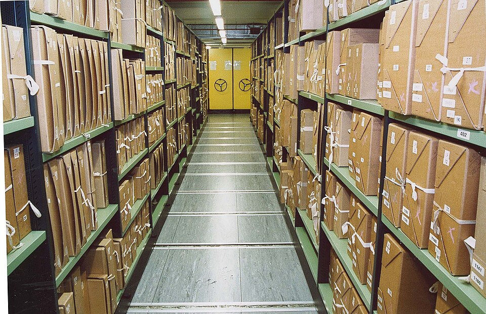 A repository at The National Archives, Kew: records boxed on numbered mobile shelving. Every box carries its catalogue reference, so any document can be found and produced.