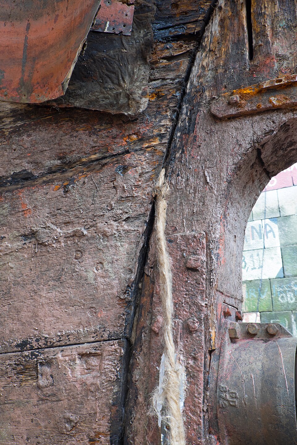 Caulking a wooden hull in Sweden, 2014: a strand of fibre driven into the seam between two planks.