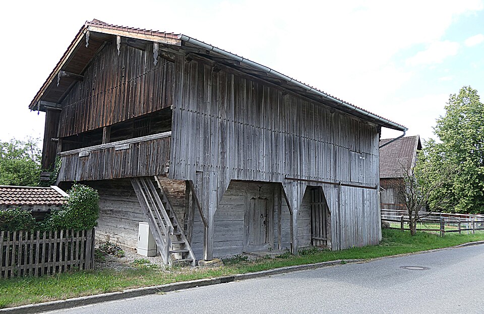 A raised timber granary in Bavaria — floor lifted clear of the ground, walls left to breathe.