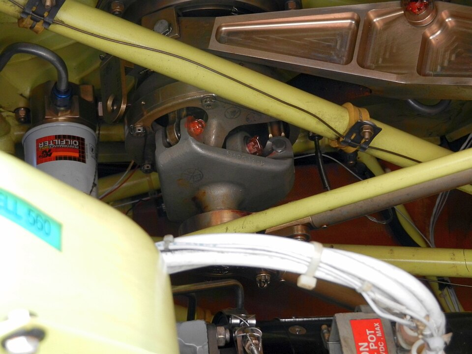 The swashplate of an Enstrom 480 helicopter: rods from the controls tilt and raise it, and links from it set the pitch of each blade.