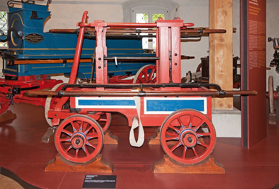 A manual fire engine built by Newsham and Ragg in 1780: crews worked the long pump bars along its sides to throw water from its tank.