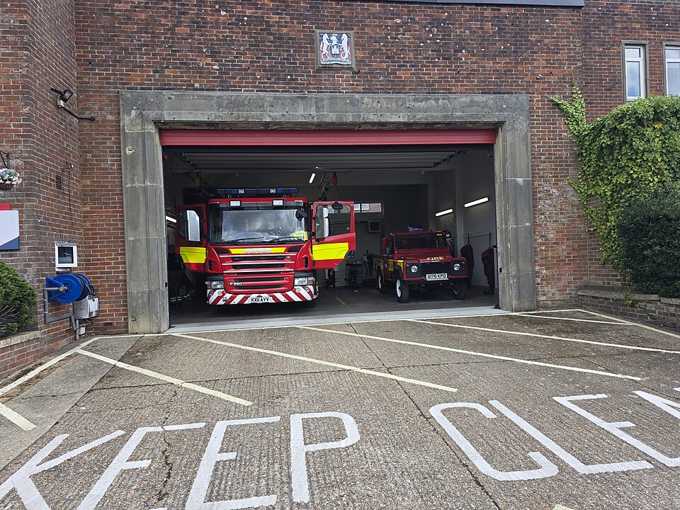 A fire station on the Isle of Wight with two appliances in the bay and the apron marked KEEP CLEAR. Response time starts at the station door.