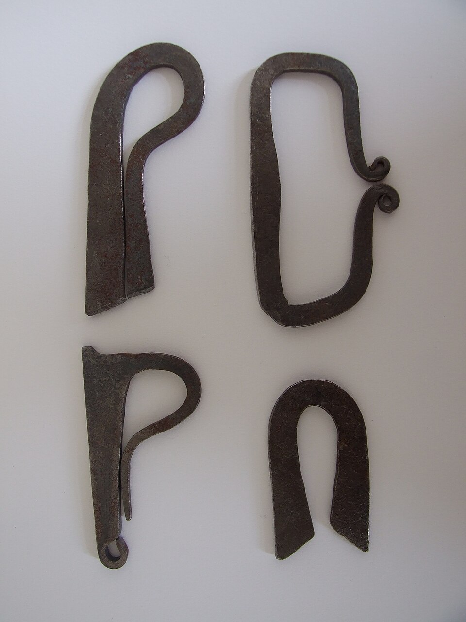 Forged fire steels. The striking face is high-carbon steel; sparks come off it, not off the flint.