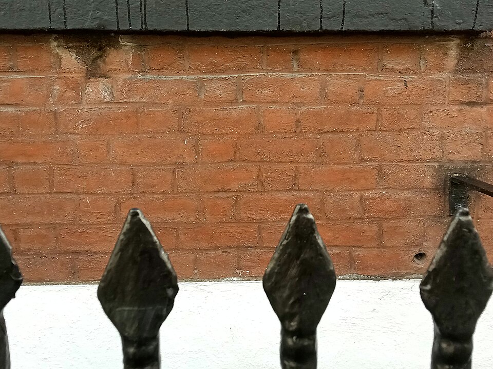 Flemish bond: every course alternates a header (short end) with a stretcher (long side), so the wall is tied through its full thickness in every course.