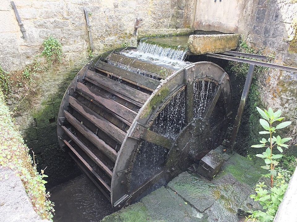 An overshot wheel at work, water entering over the top of the wheel rather than under it.