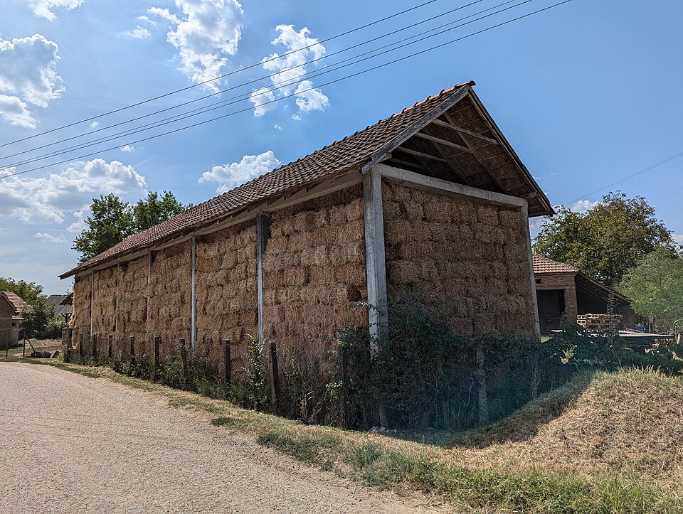 A hay barn at Kovačevac (2024): a roofed store that holds nothing but hay, built as a building of its own.