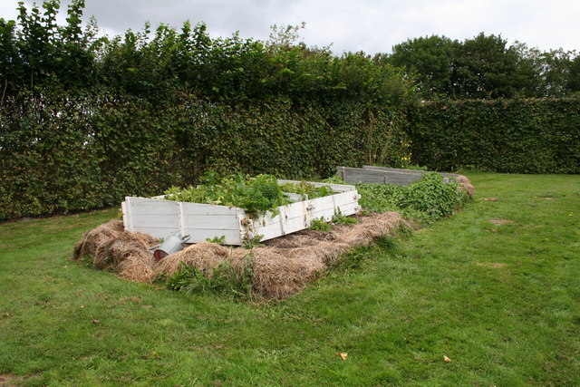 Hotbeds as Gilbert White used them for melons at Selborne: wooden frames set on a bed of fresh horse manure and straw, which heats the soil above it as it rots.
