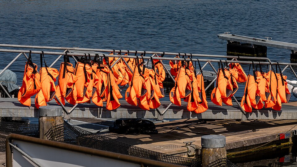 Lifejackets hung ready on a marina pontoon, Kühlungsborn, Germany, 2024.