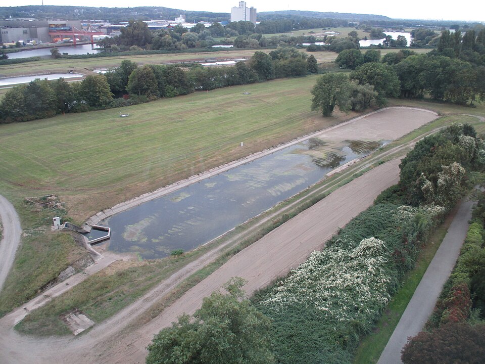 An open slow sand filter bed — a shallow sheet of water standing over a wide area of fine sand.