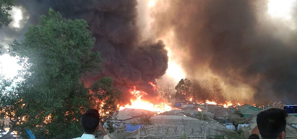 The Cox's Bazar camp fire of 22 March 2021: closely packed shelters of bamboo and sheeting burning together.