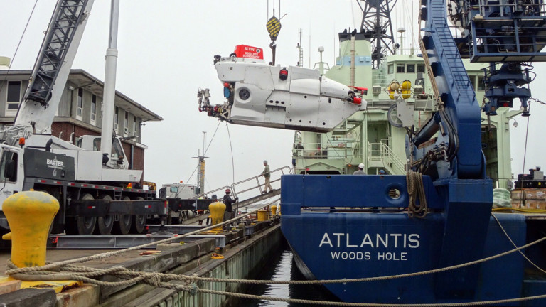 The research submersible Alvin being lifted off its support ship, Atlantis, in port in May 2016. It carries a pilot and two scientists.
