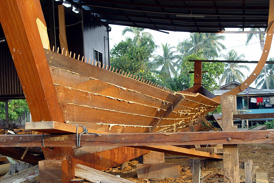 A plank hull being built shell-first in Malaysia, 2004: the planks are joined edge to edge before any frame goes in.