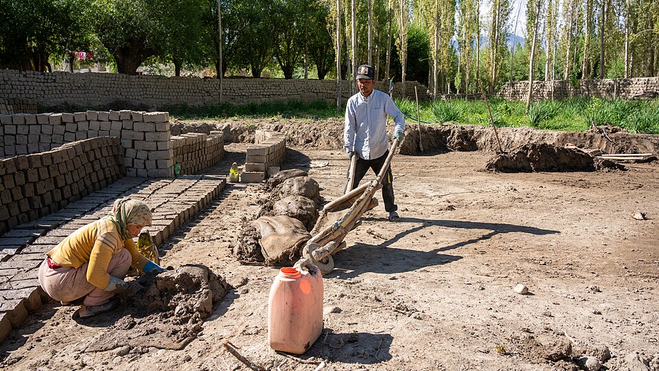Making mudbricks in Ladakh — mud and straw pressed in a mould and turned out to dry in rows. Sun-dried, never fired.