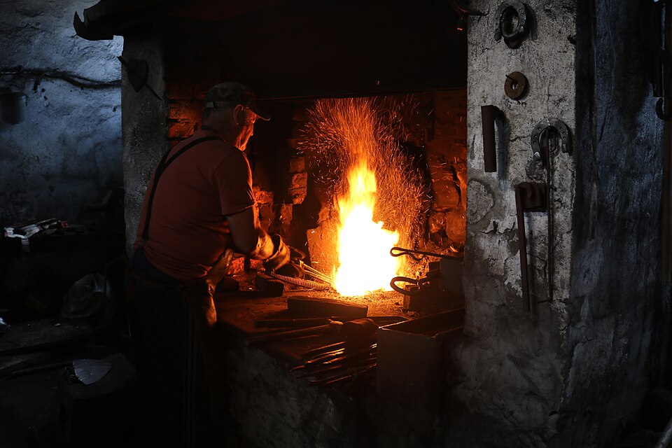 The forge fire at working heat in a village smithy, Lysychovo, Ukraine.