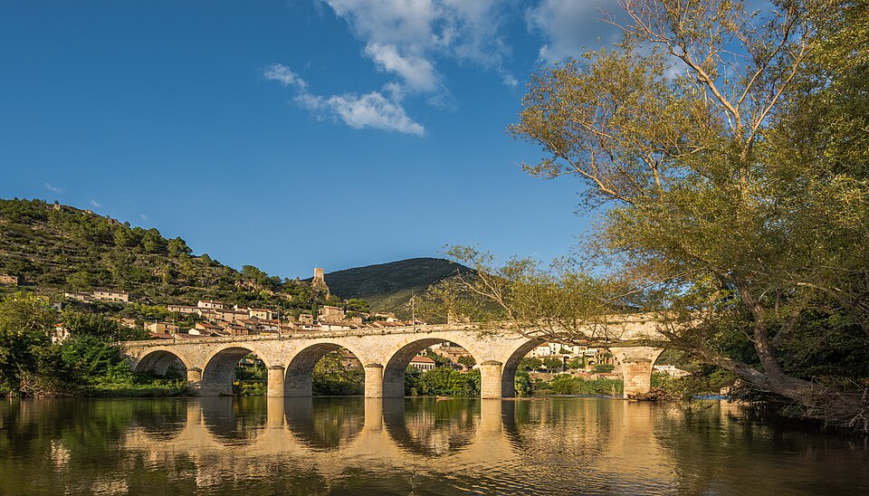 A masonry arch bridge over the Orb at Roquebrun. An arch works in compression alone, which is what lets stone — strong in compression, weak in tension — span water.