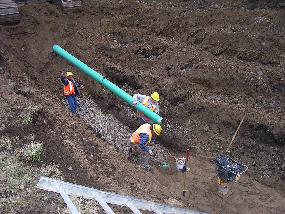 Sewer pipe going into a trench. Unglamorous, and it saves more lives than any hospital.