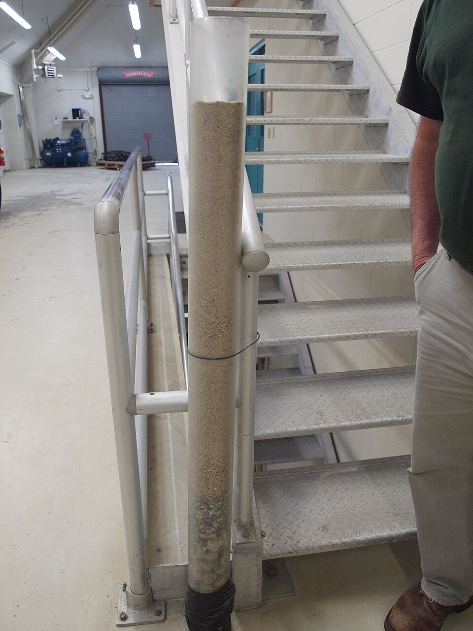 A column showing the media profile — fine sand on top, graded gravel supporting it below.