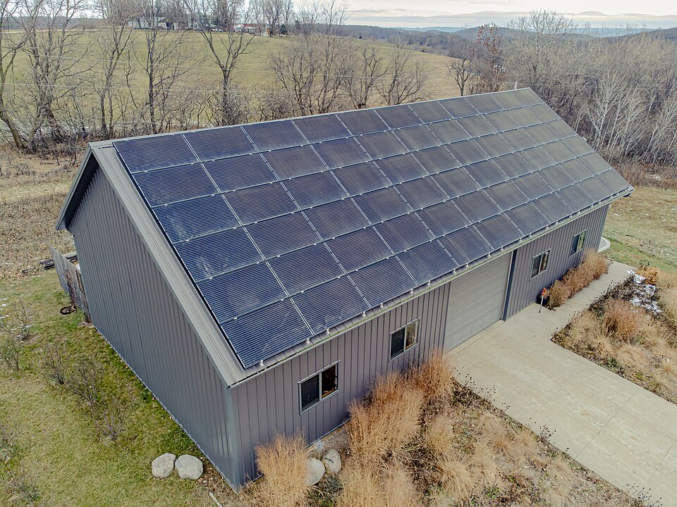 Photovoltaic panels covering a building's roof. Panels make DC electricity whenever light reaches them; there is no way to switch a panel off in daylight except to cover it.