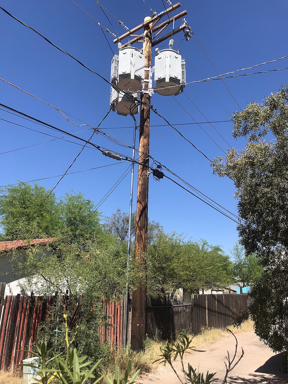 Transformers on a distribution pole, stepping the local distribution voltage down to the voltage used in houses. Every conductor above them is at a voltage that kills.