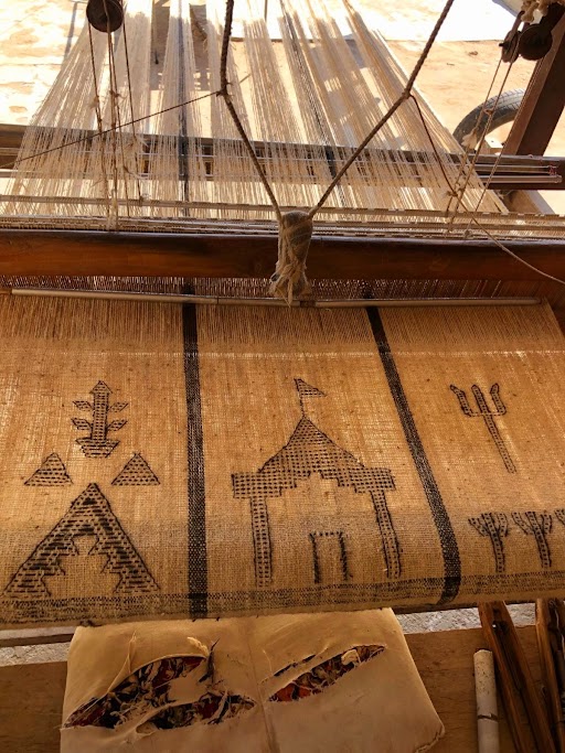 A handloom in Kachchh, Gujarat, with the warp under tension and the pattern building up.